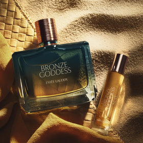 Estée Lauder Bronze Goddess Nuit spray applied from travel bottle for easy on‑the‑go refresh