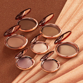 Estée Lauder compact in hand showing scale and travel-friendly benefit
