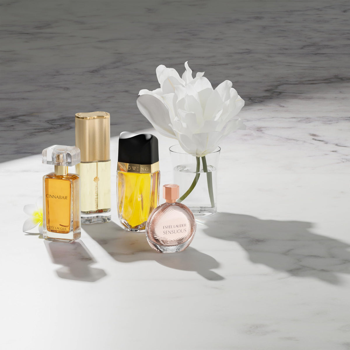 Estée Lauder Cinnabar on a dresser in evening setting evoking warm, sensual atmosphere
