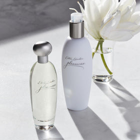 Estée Lauder Pleasures surrounded by lilies and peonies, conveys floral notes and freshness