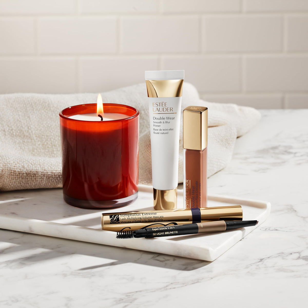 Estée Lauder primer on bathroom counter styled in a morning routine scene for lifestyle appeal