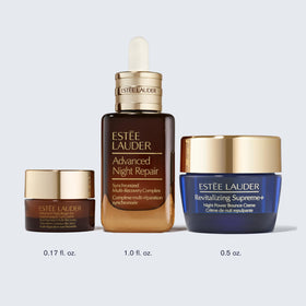 Estée Lauder products held in hand for scale to show travel-friendly sizes and portability