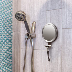 Ettori mirror next to ruler for scale showing compact size and easy placement benefit
