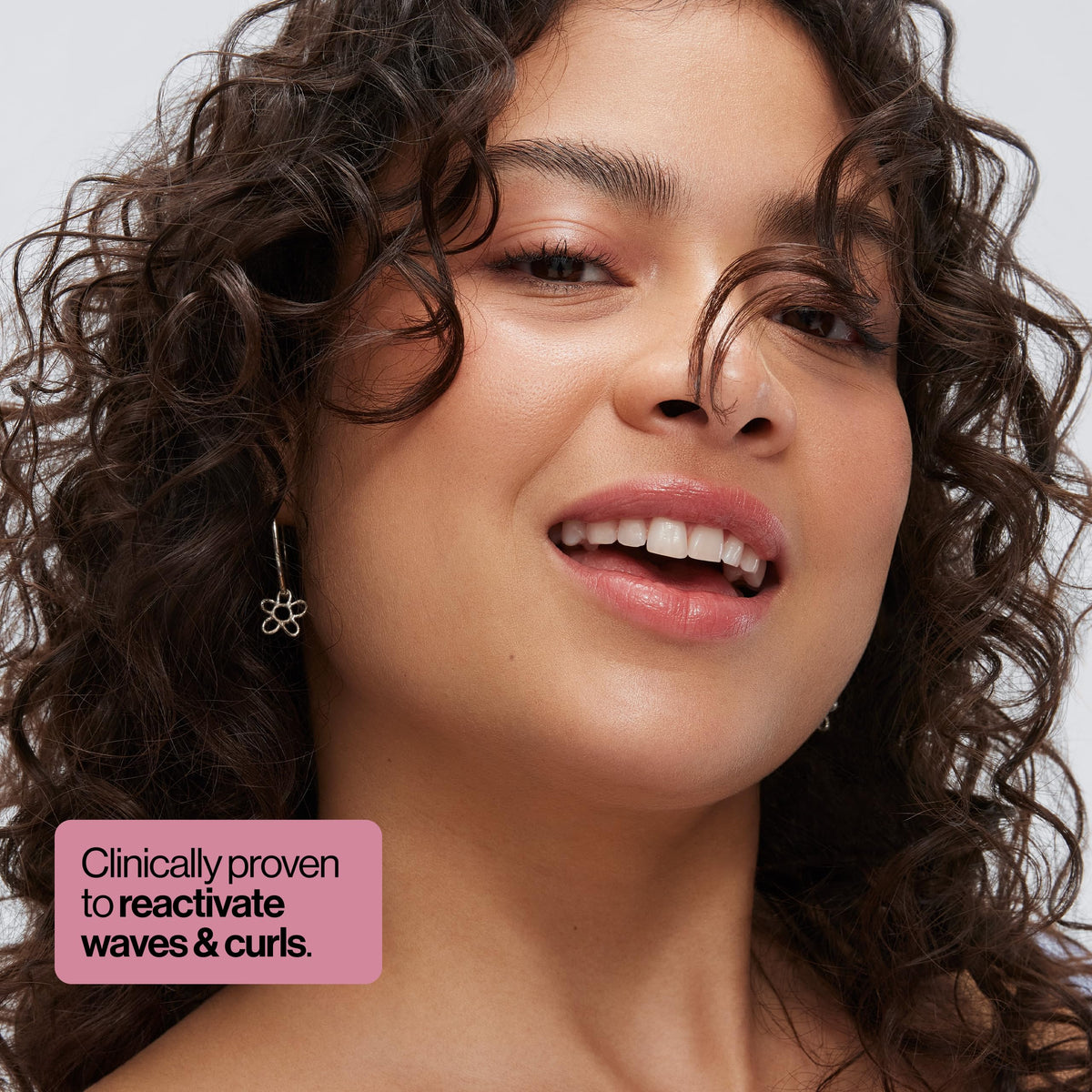 EVA·NYC fine mist spraying, demonstrating even dewy coverage for refreshed curls