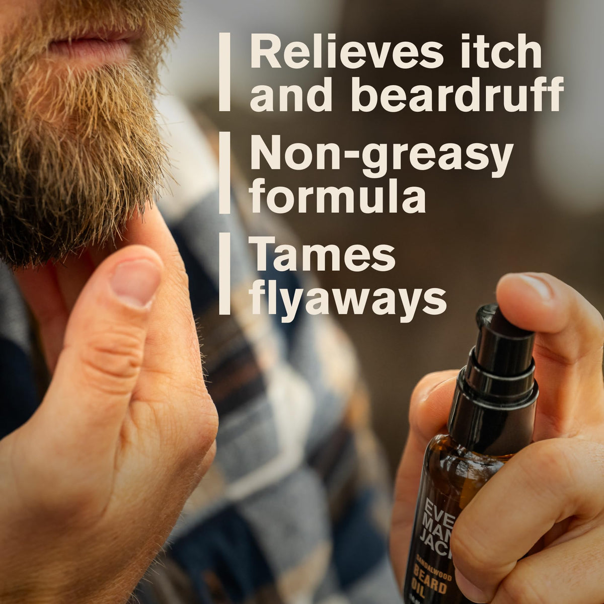 Every Man Jack bottle held in hand to show 1 fl oz scale and travel-friendly convenience