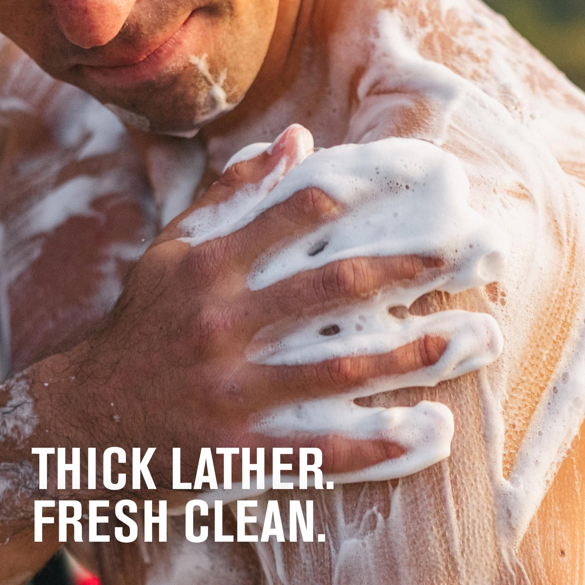 Every Man Jack bottle in shower hand applying body wash for convenience