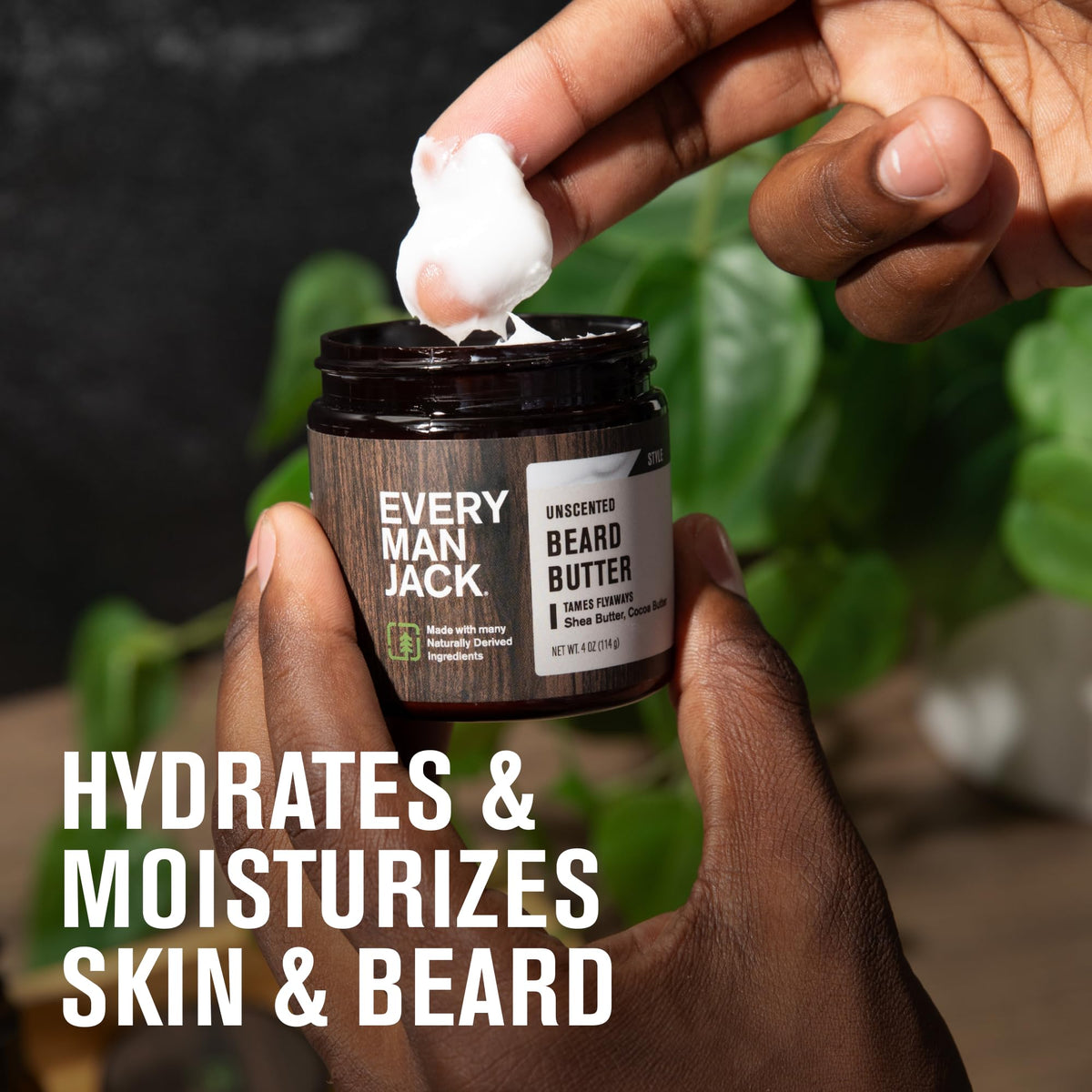 Every Man Jack man applying beard butter in mirror for hydration