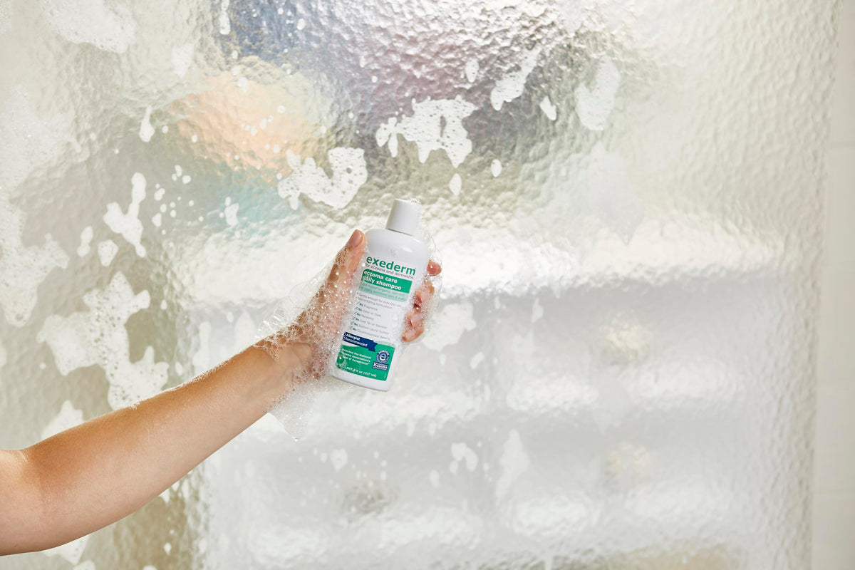 Person using Exederm in shower illustrating soothing scalp care