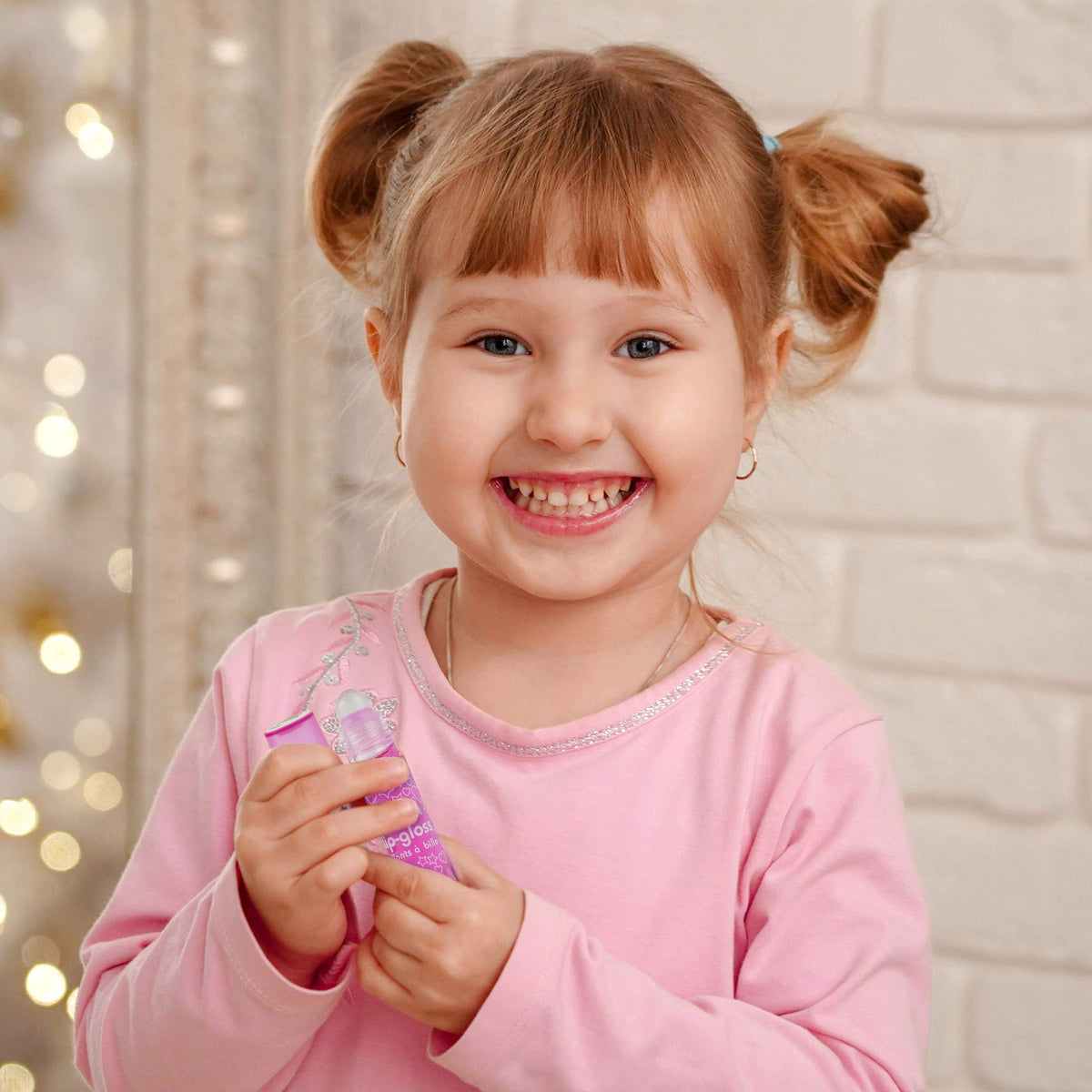 Expressions Girl child using gloss with parental supervision for safe application