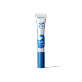 Eyeko tube in a beach bag illustrating waterproof, on-the-go reliability