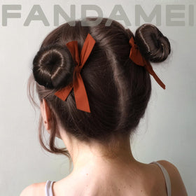 Fandamei donut beside a hand to show compact size and easy handling