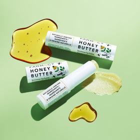 Farmacy beeswax lip balm ingredients display with honey and butters for nourishment