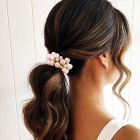 Fashey scrunchie stretched to show elastic core flexibility and strong hold advantage