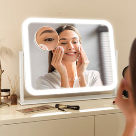 FENNIO mirror on vanity beside makeup items showing compact size benefit