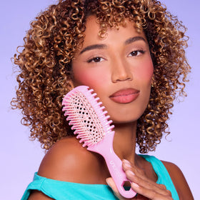 FHI Heat brush being rinsed to highlight easy cleaning and hygiene benefit