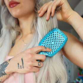 bathroom countertop lifestyle with UNbrush for everyday quick and gentle detangling