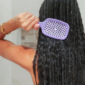 FHI Heat UNbrush being rinsed under water showing easy cleaning and quick-dry vented design