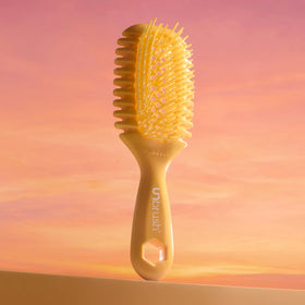 FHI Heat UNbrush Curl held in hand to show scale and lightweight 1.5 oz handling