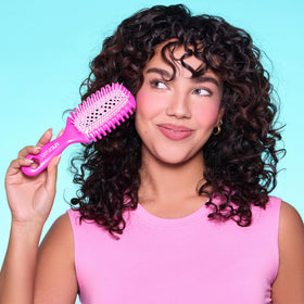 FHI Heat brush held in hand illustrating 1.5 oz lightweight styling control