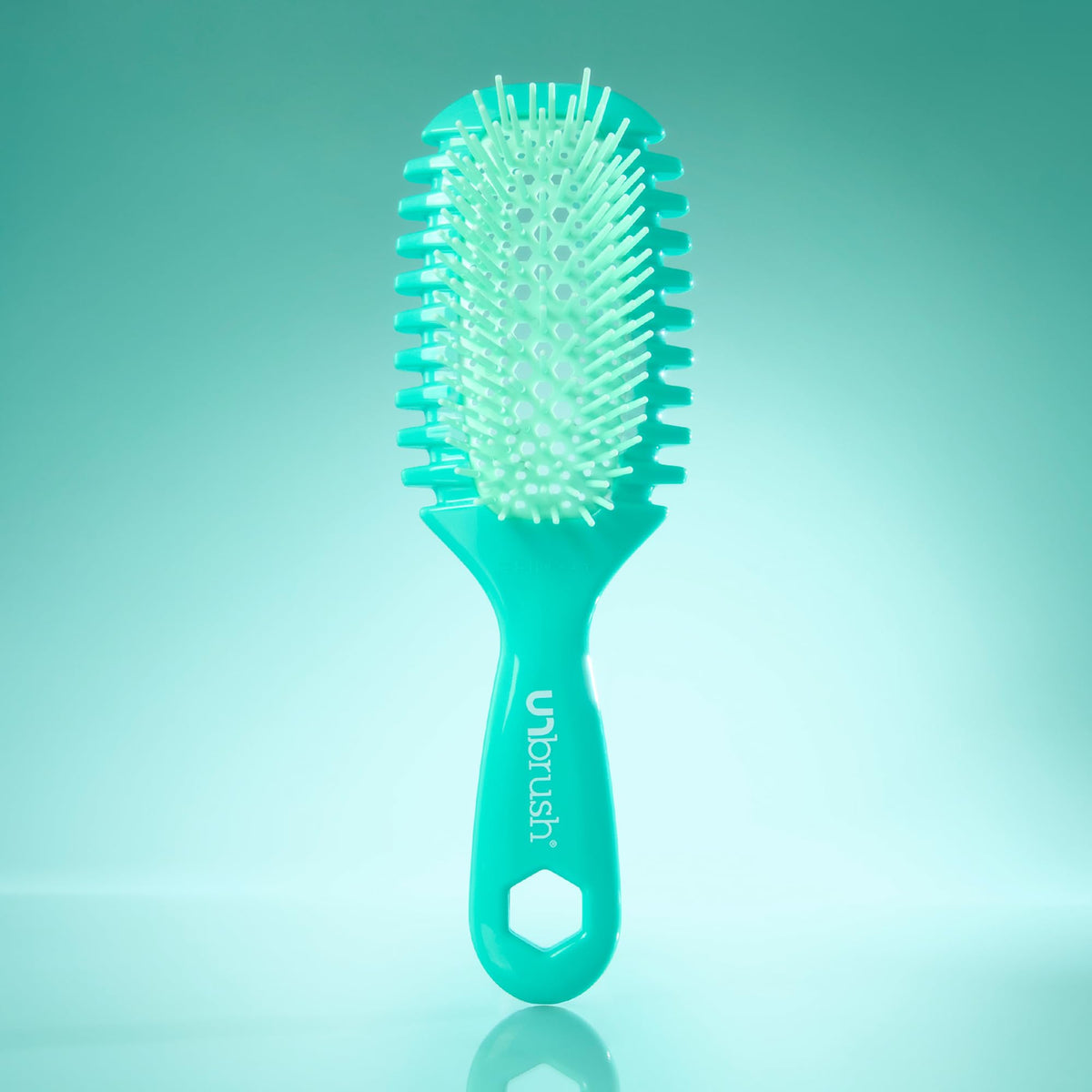 FHI Heat UNbrush Curl held in hand for scale, emphasizing its ultra-light 1.5 oz design