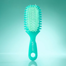 FHI Heat UNbrush Curl held in hand for scale, emphasizing its ultra-light 1.5 oz design