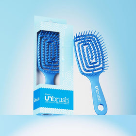 FHI Heat brush in hand for scale showing lightweight, travel-friendly design