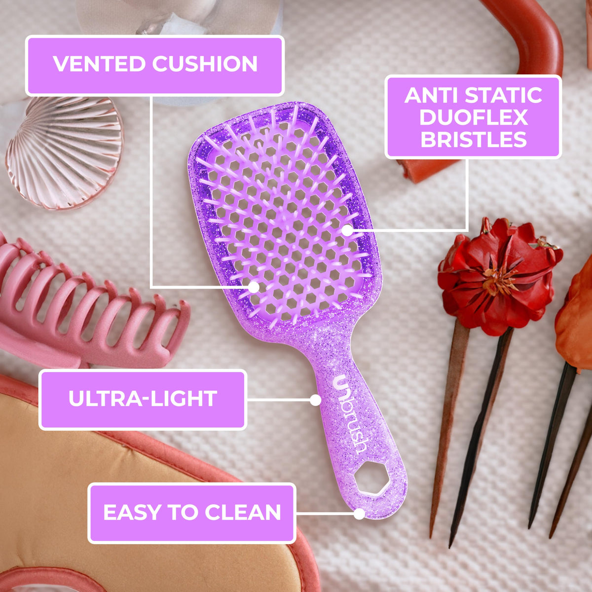 FHI Heat UNbrush in hand scale comparison showing 1.5 oz lightweight feel for effortless brushing