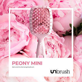 FHI Heat UNbrush Mini being rinsed under water showing simple, hygienic cleaning benefit