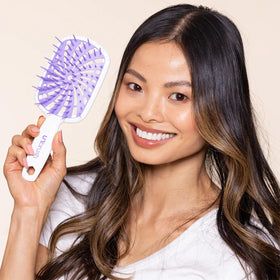 FHI Heat brush under running water showing easy cleaning and long-lasting performance