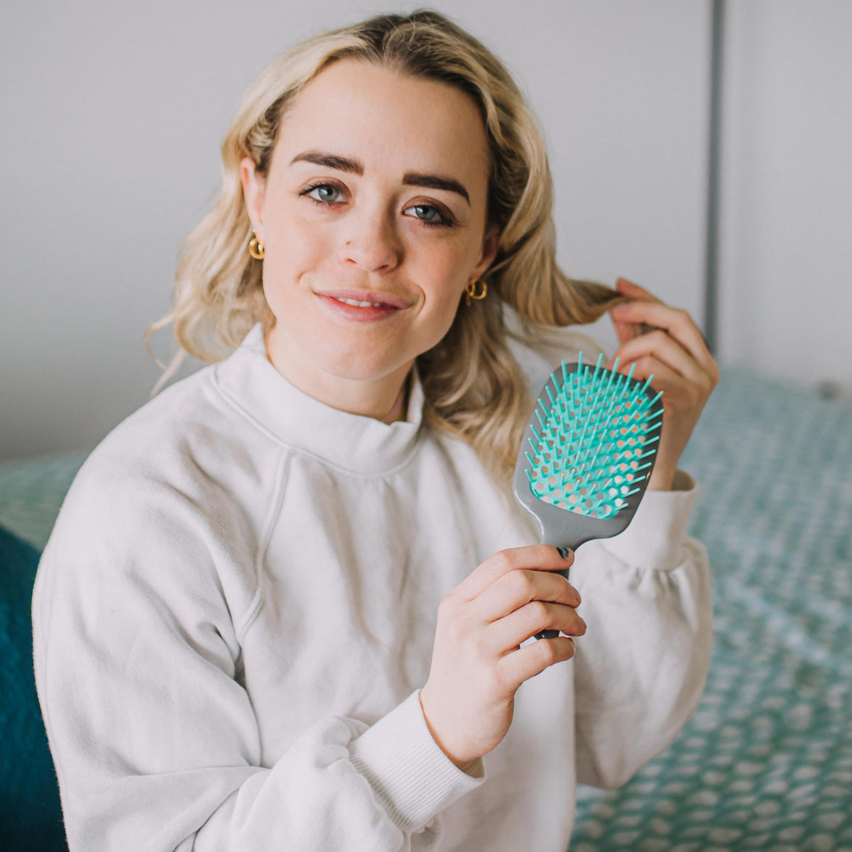 FHI Heat UNbrush size comparison beside a phone for portable styling convenience