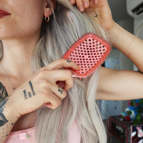 FHI Heat UNbrush packed in a travel bag showing portability and styling on the go