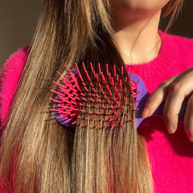 FHI Heat UNbrush packed in a toiletry bag for travel-ready convenience and quick touch-ups