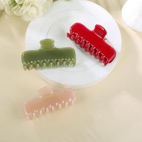 FidesAmor clip beside a hand to show 3.8 inch size and easy handling benefit