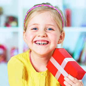 Fishdown headband worn by smiling child showing comfortable fit and tidy hair benefit