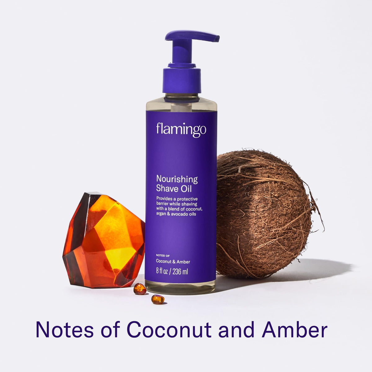 Flamingo bottle beside coconut, argan, avocado to show natural oils