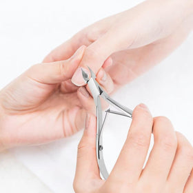 Flauntia nipper next to a ruler for scale showing compact travel-ready size