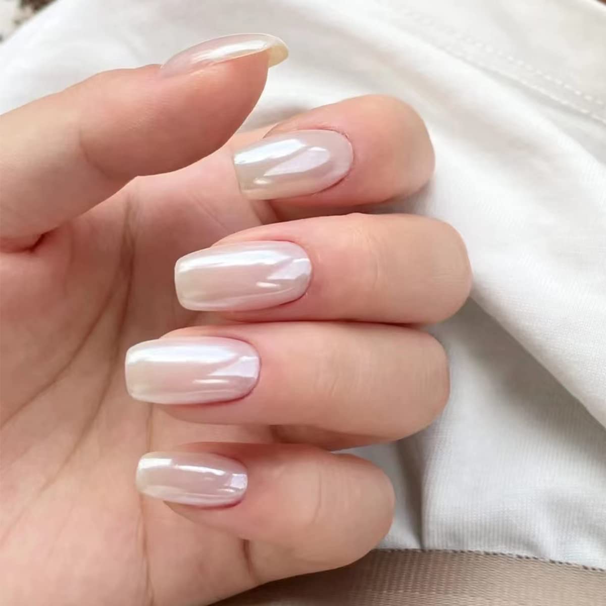 Fokostar French tip mani with pearl chrome accents adding subtle luxury touch