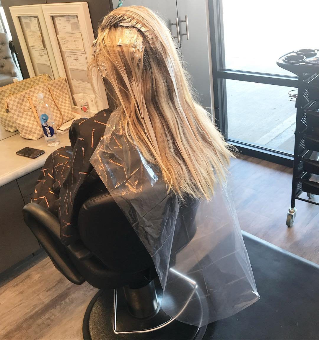 FRAMAR bib catching hair clippings on cape to keep clients and chairs clean