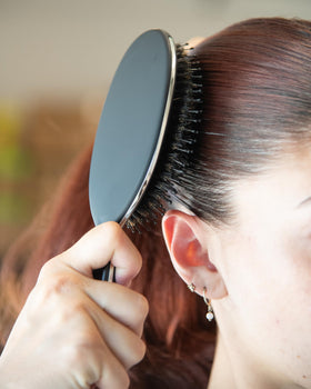 FRAMAR brush back and handle profile showing ergonomic grip for comfortable styling