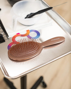 FRAMAR close-up of flexible bristles detangling knots, protects hair from breakage