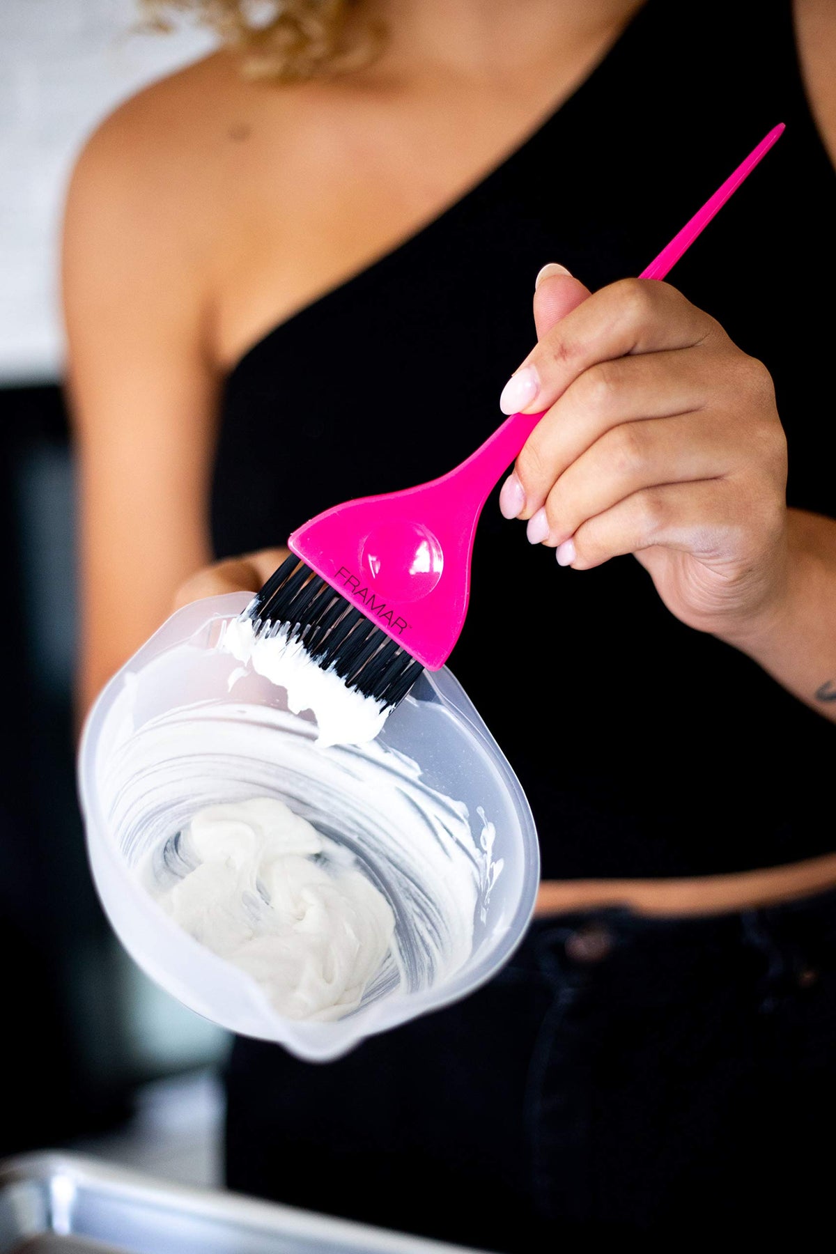 FRAMAR bowl in use with brush mixing hair color for efficient application