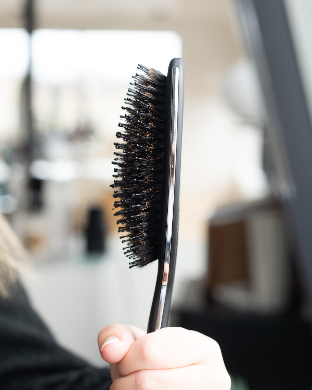 FRAMAR brush on a bathroom vanity in a styling scene showing daily grooming use