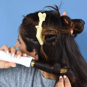 FRAMAR clip pinning a casual bun illustrating secure hold for everyday wear