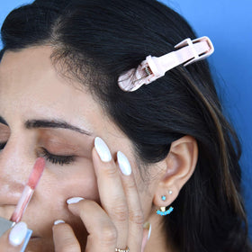 FRAMAR clips beside a hand to show size and ease of handling for comfortable use