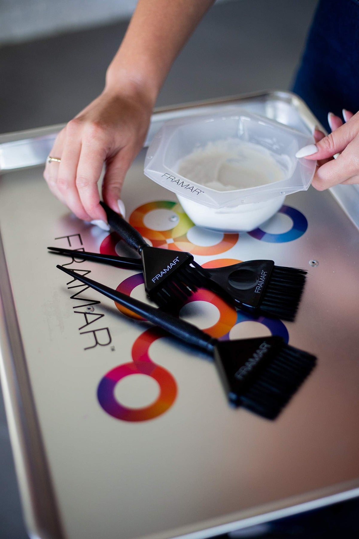 FRAMAR brushes in hand showing size and ergonomic grip for comfort