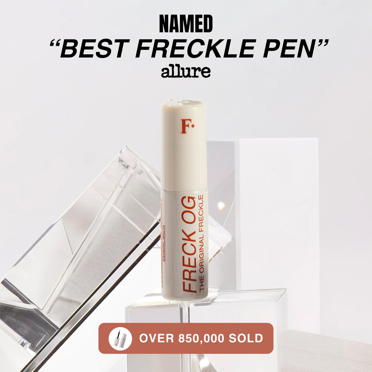 Freck Beauty pen next to wallet showing travel-ready compact size