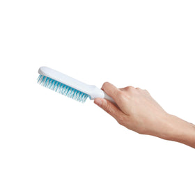 Frida Baby brush used on towel-dried hair showing effective wet detangling
