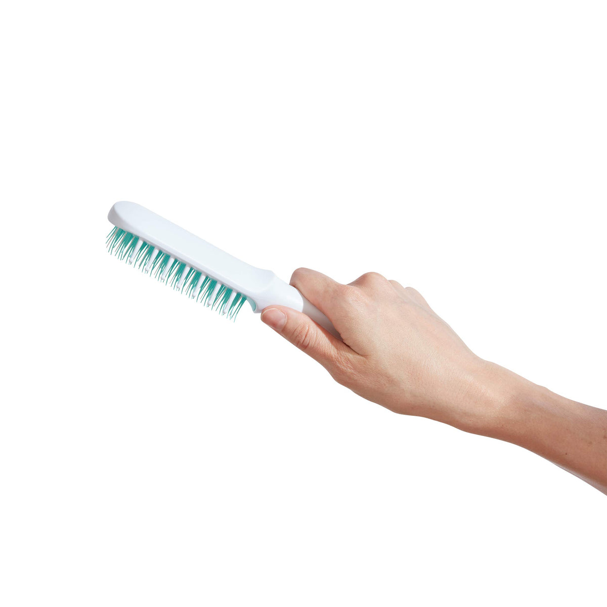 Frida Baby brush being used on a toddler's curly hair, smoothing tangles with minimal fuss