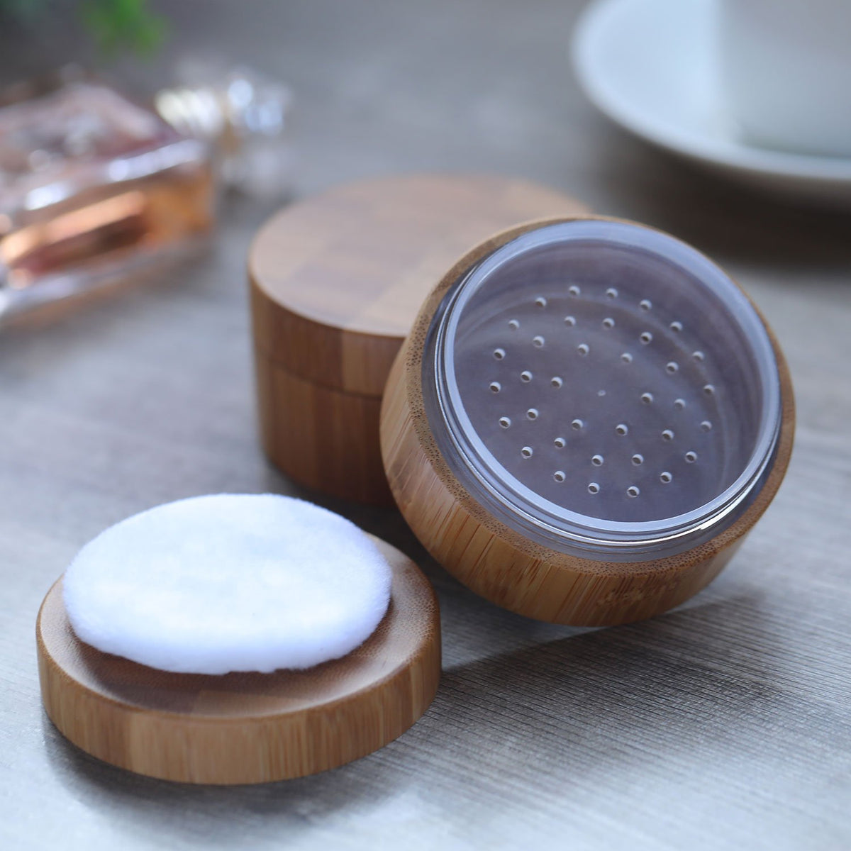 Frienda jar open with powder inside showing neat storage and puff placement