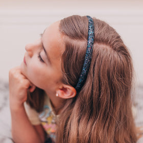 FROG SAC headband worn by child outdoors demonstrating stable hold during play